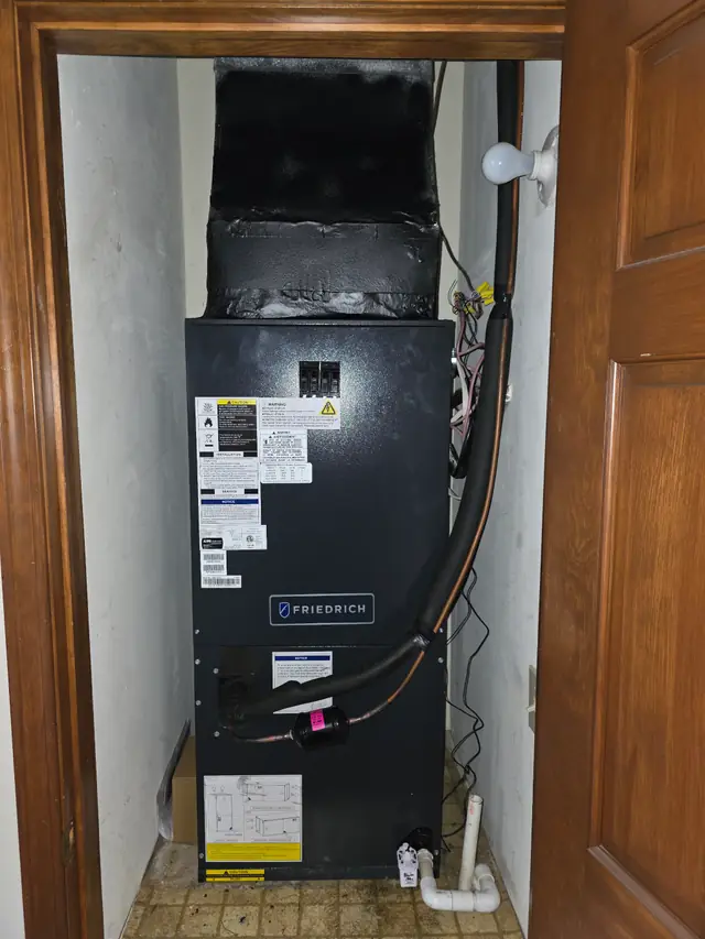 An air handler installed in a hallway closet