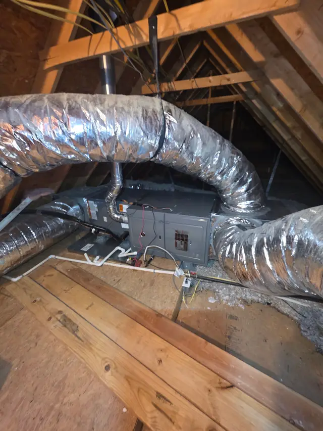 Insulated flex duct installed between attic rafters